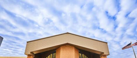 A building with a flat roof, large windows, and a brick facade.
