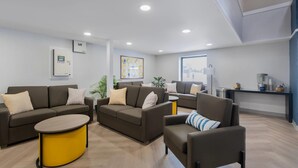 A modern living room with sofas, a coffee table, and a small side table.