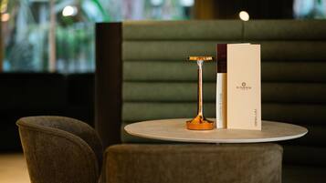 A round table with a menu, a menu stand, and a chair.