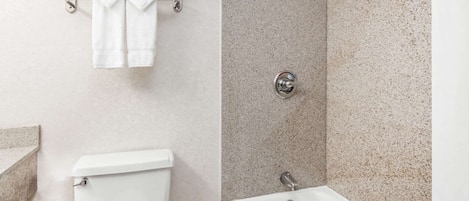 A bathroom with a toilet, a sink, and a bathtub.