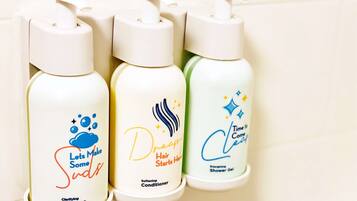 Three bottles of hair care products on a shelf.