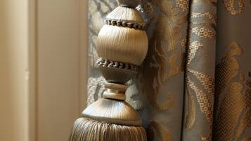 A close-up of a curtain with a tassel and a decorative knot.