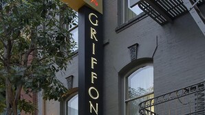 A hotel entrance with a sign for 'Hotel Griffin' and 'Perry's' below it.