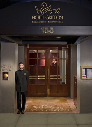 A hotel entrance with a double door, a doormat, and a sign above the door. - Hotel Griffon (San Francisco)