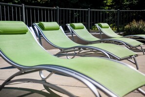A row of green lounge chairs with metal frames, arranged in a row on a paved surface. - Holiday Inn Princeton by IHG (Princeton)