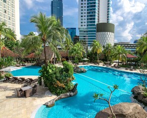 Una piscina al aire libre, sillones reclinables de piscina