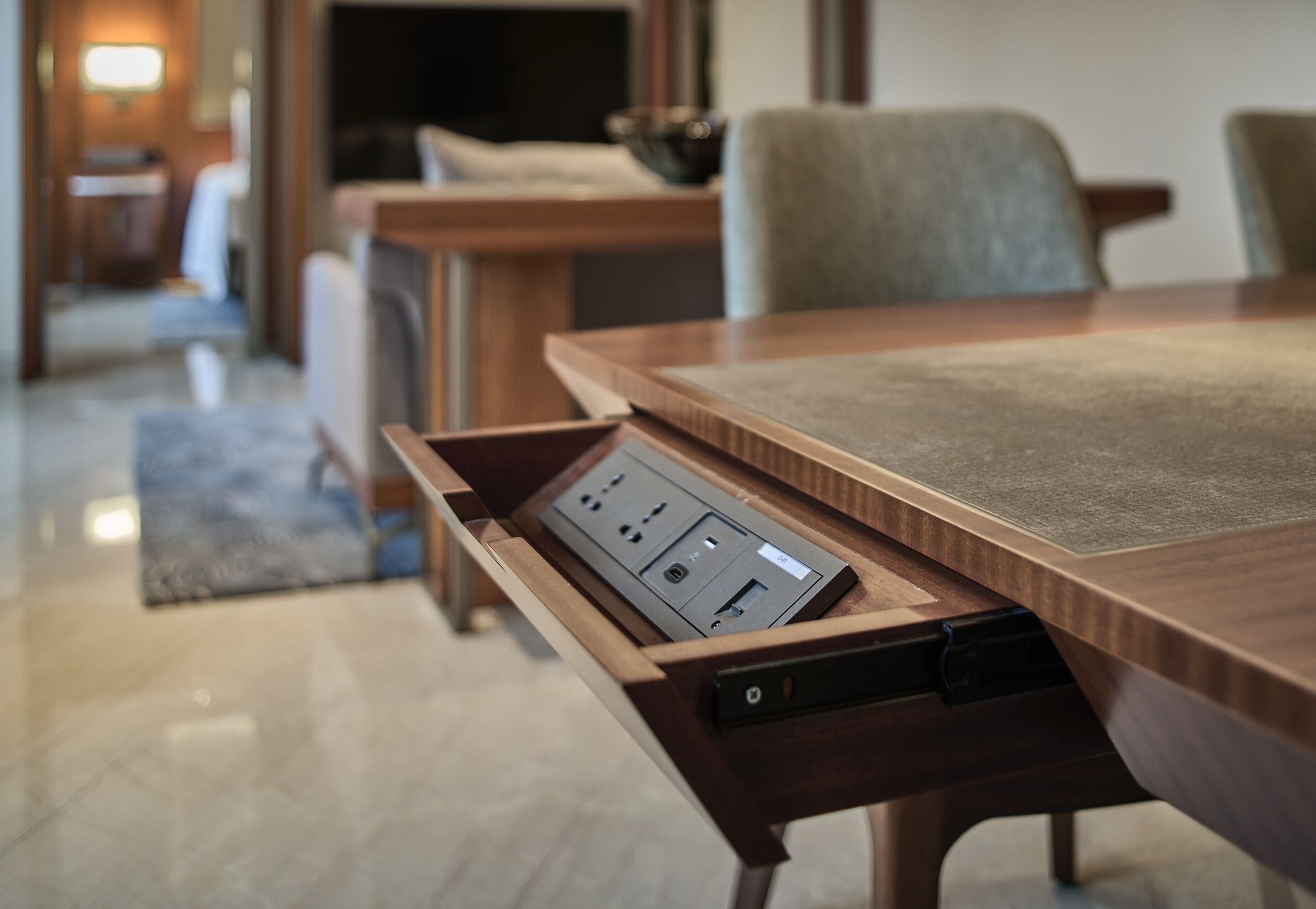 A conference table with a built-in power strip and a drawer.