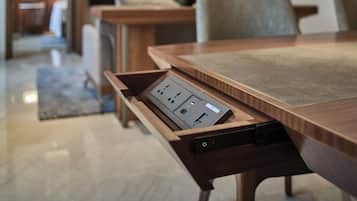 A conference table with a built-in power strip and a drawer.