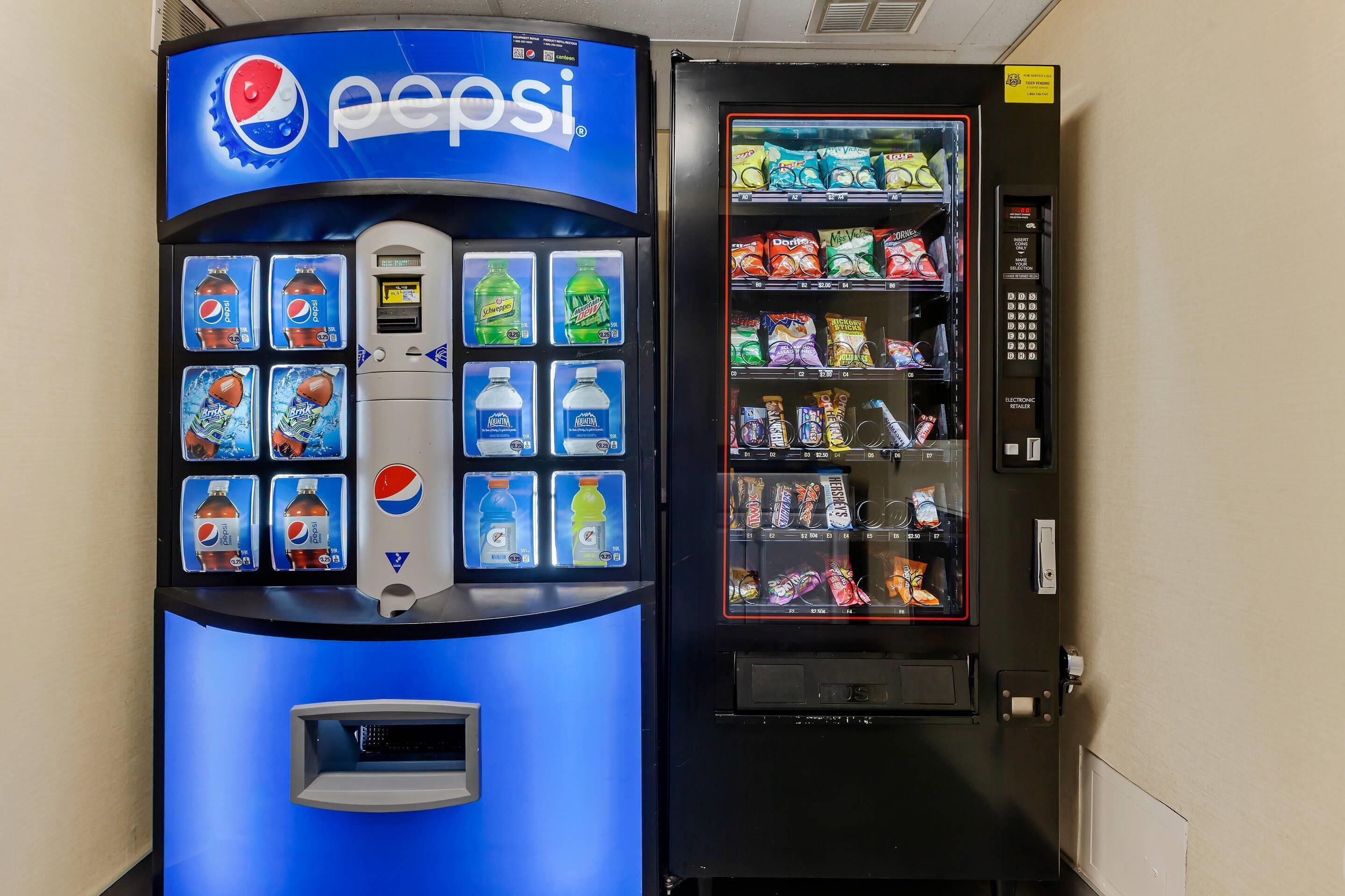 A vending machine with Pepsi and Mountain Dew options, and a snack vending machine with various snacks.