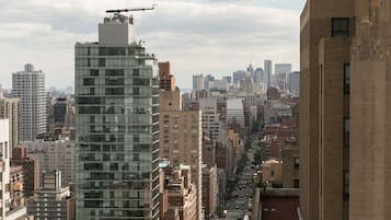 A cityscape with a variety of high-rise buildings, including a prominent glass skyscraper and older brick structures.