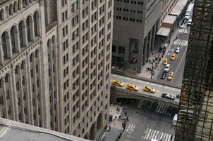 A high-rise building with a grid of windows and a street below.