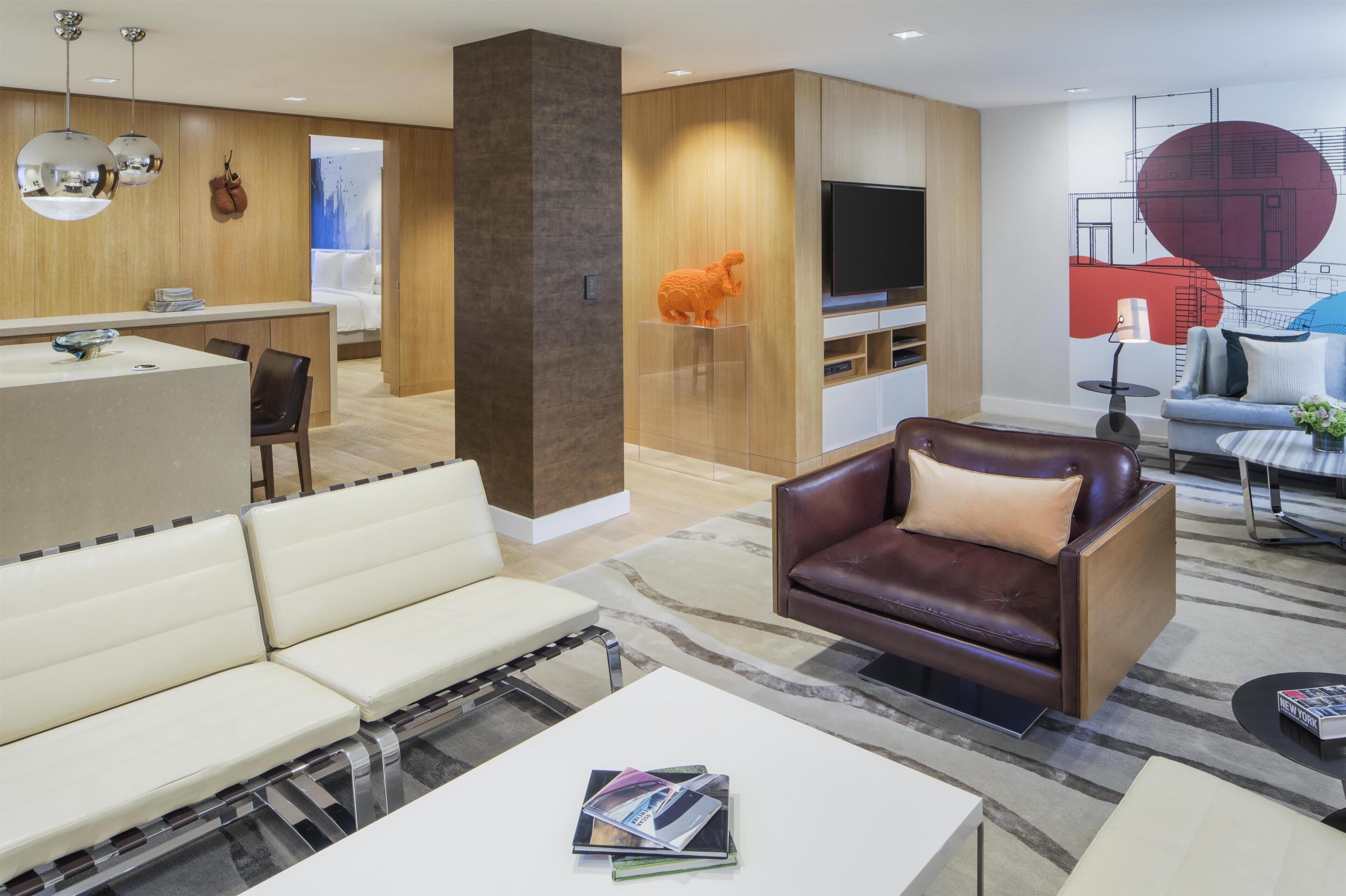 A modern living room with a sofa, a coffee table, and a TV.