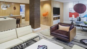 A modern living room with a sofa, a coffee table, and a TV.
