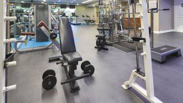 A gym with various exercise equipment, including weight machines and free weights.