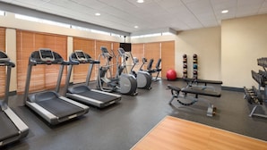 A gym with treadmills, elliptical machines, a bench press, and weight machines. - Hampton Inn Denver West Federal Center (Lakewood)