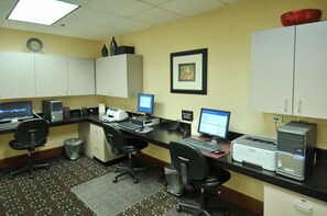 A hotel office with multiple computer workstations, a printer, and a lift receiver for guest assistance. - Hampton Inn Denver West Federal Center (Lakewood)