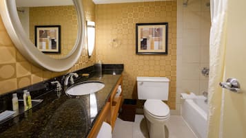 A bathroom with a sink, toilet, and bathtub.