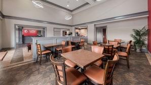 A hotel lobby with multiple seating areas, a reception desk, and a bar area. - SureStay Plus Hotel by Best Western San Antonio North (San Antonio)