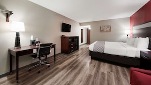 A hotel room with a bed, desk, chair, and a TV on the wall. - SureStay Plus Hotel by Best Western San Antonio North (San Antonio)