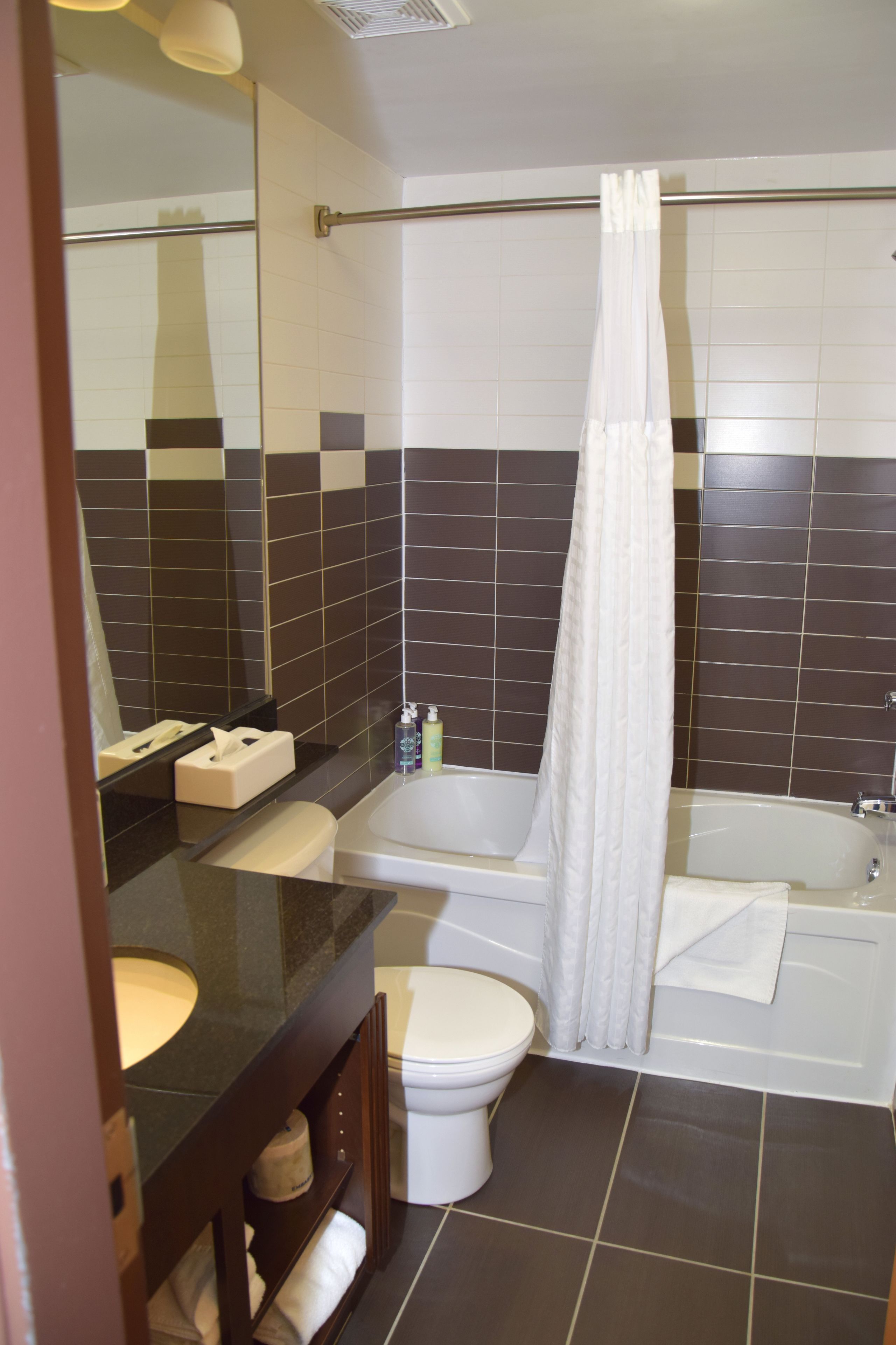 room, 1 queen bed (coast limited queen) | bathroom | bathtub, eco-friendly toiletries, hair dryer, towels