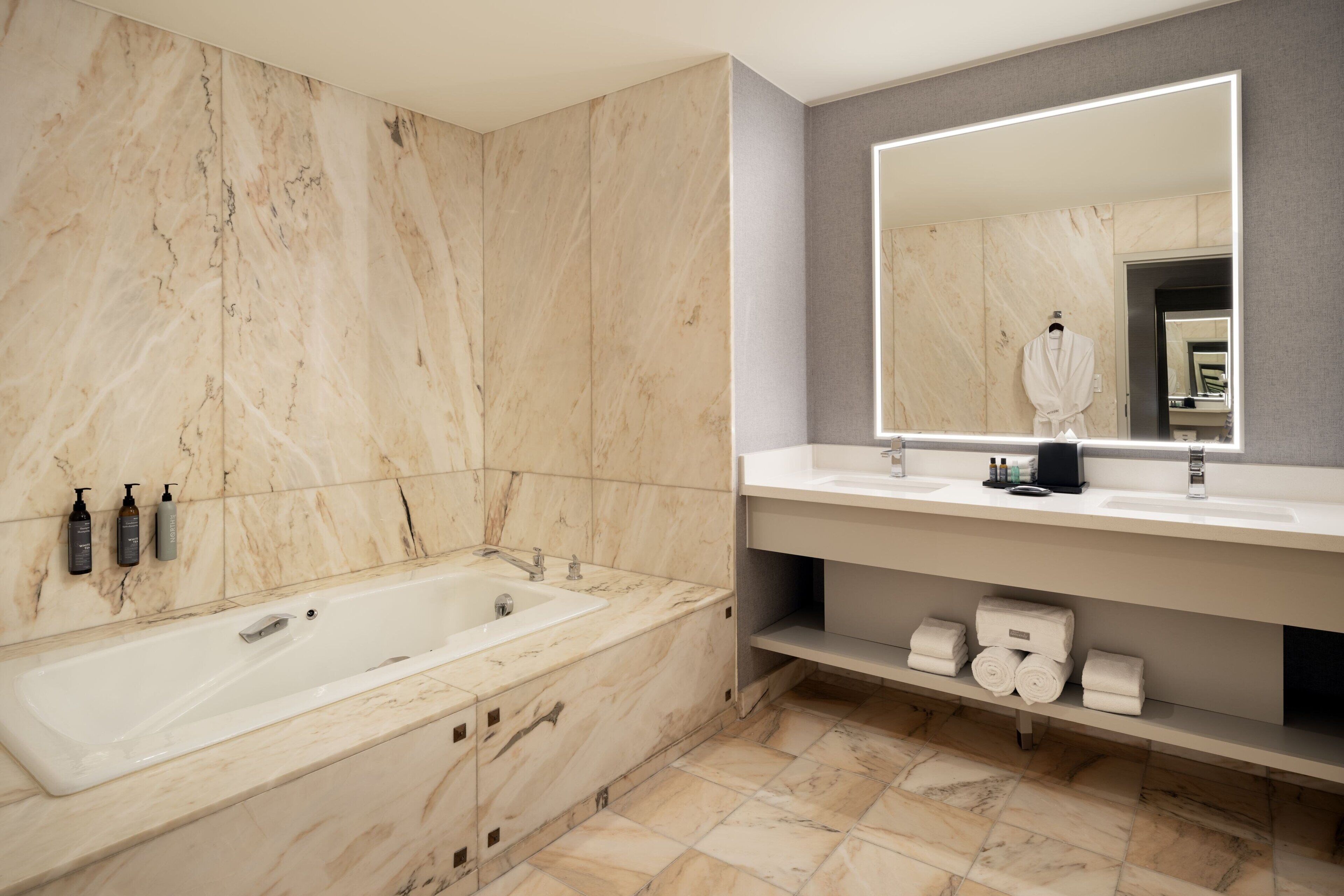 luxury suite, 1 king bed, non smoking, mountain view | bathroom | combined shower/bathtub, designer toiletries, hair dryer, bathrobes