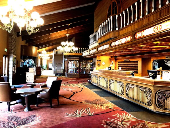 A lobby with a reception desk, seating area, and a staircase leading to an upper level. - DoubleTree by Hilton Durango (Durango)
