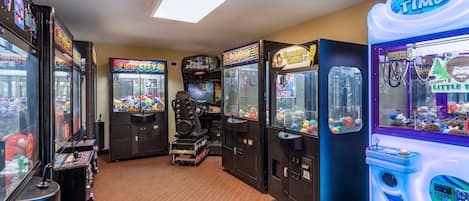A row of arcade games in a room with a striped carpet.
