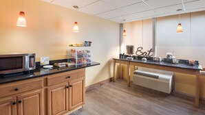 A kitchenette with a microwave, a coffee machine, and a water dispenser. - Best Western Inn (Goshen)