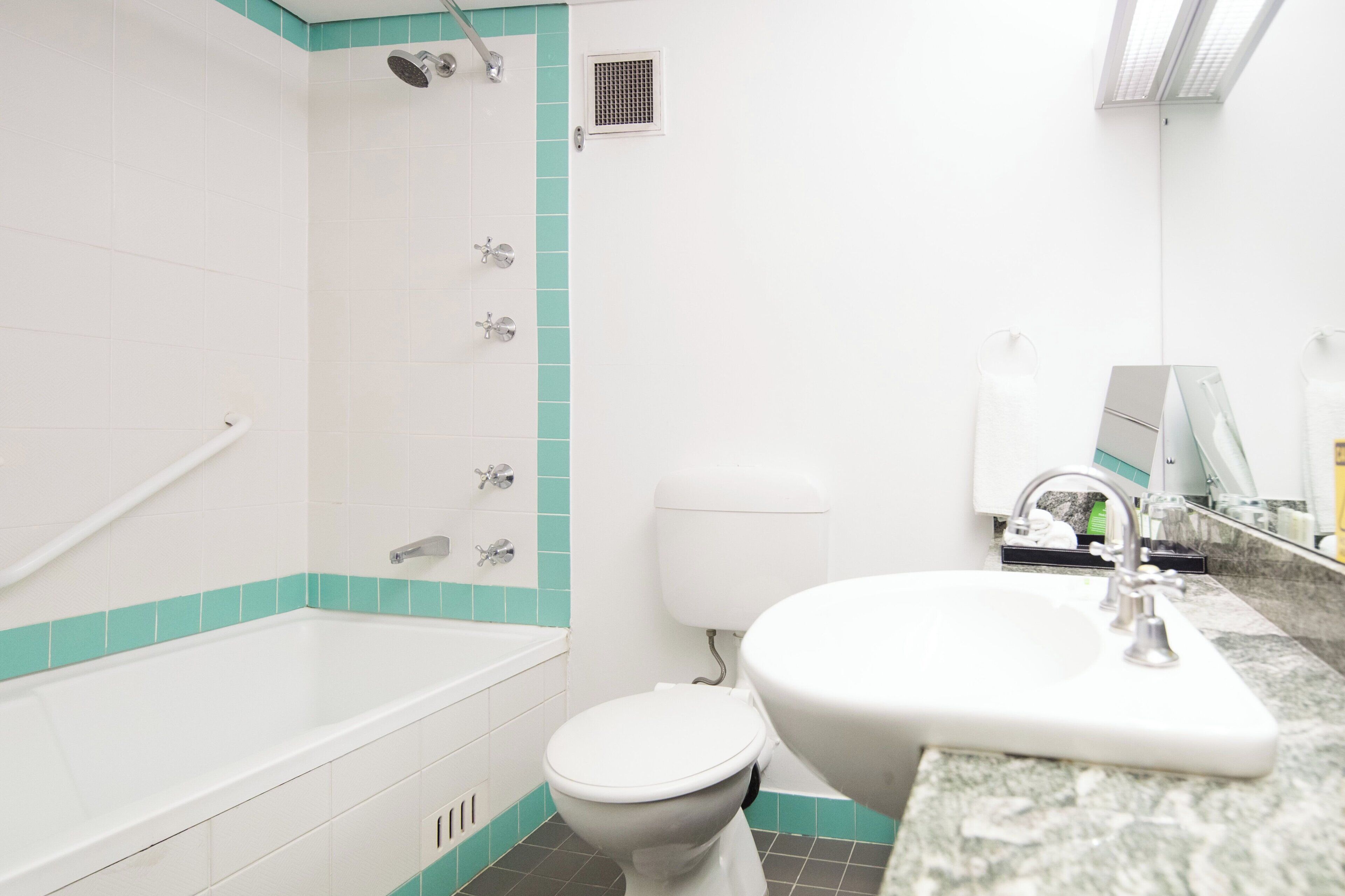 A bathroom with a bathtub, toilet, and sink.