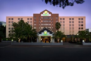 A Holiday Inn hotel with a modern facade, multiple floors, and a prominent entrance.