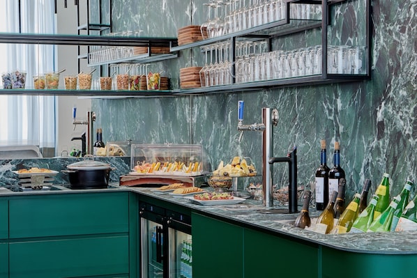A buffet setup with various food items, a wine selection, and a coffee station.