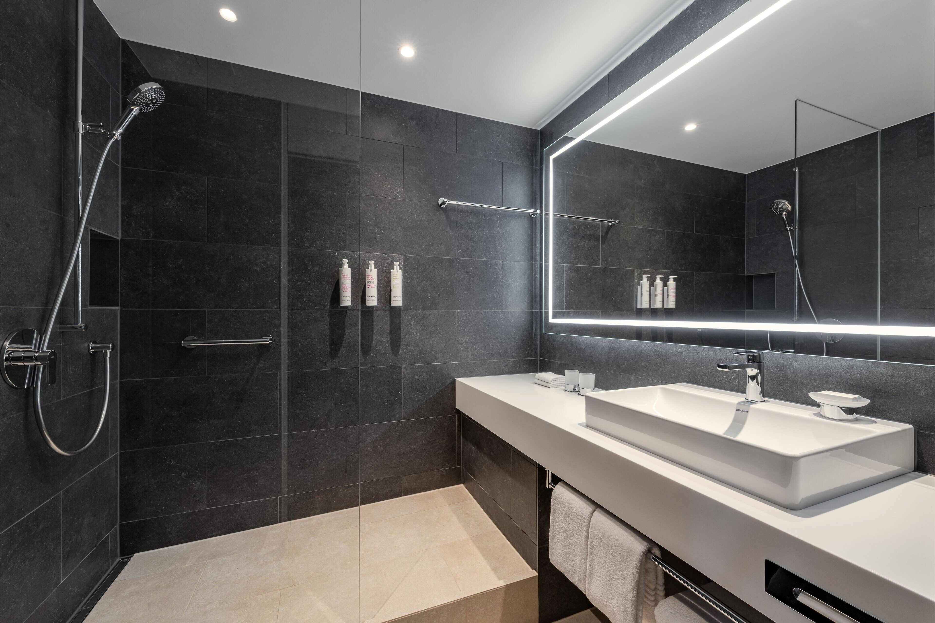 combined shower/bathtub, designer toiletries, hair dryer, slippers