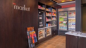A kitchenette with a refrigerator stocked with beverages and snacks, a microwave, and a sink. - Courtyard Fairfax Fair Oaks (Fairfax)