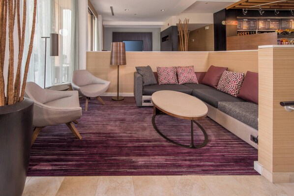 A modern living area with a sofa, two armchairs, a coffee table, and a floor lamp. - Courtyard Fairfax Fair Oaks (Fairfax)