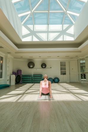 A spacious room with a skylight, exercise equipment, and a yoga mat. - JW Marriott Turnberry Resort & Spa (Aventura)