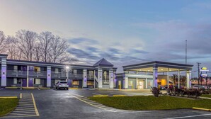 A motel with a gas station, multiple parking spaces, and a covered outdoor area. - Days Inn by Wyndham Fredericksburg North (Fredericksburg)