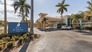 A hotel entrance with a sign reading "BOCA BY THE SEA HOTEL". - Boca By the Sea (Boca Raton)
