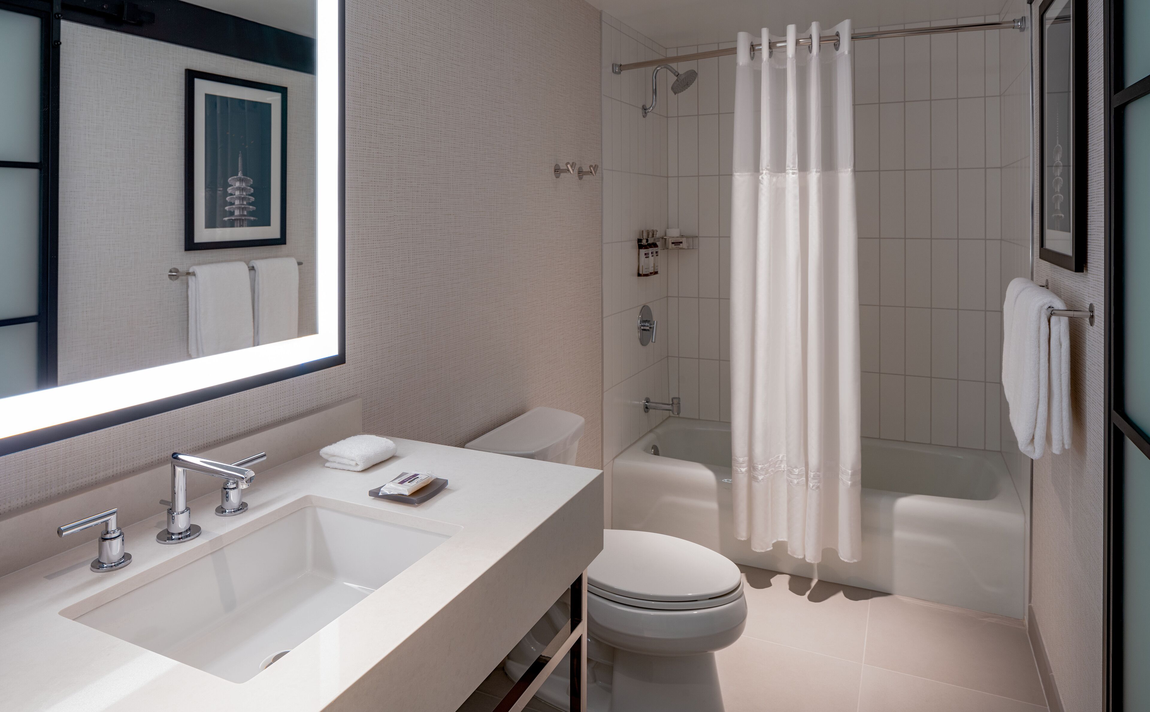 combined shower/bathtub, designer toiletries, hair dryer, towels