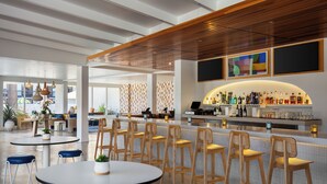 A modern bar area with wooden bar stools, a counter with bottles, and a seating area with round tables and chairs. - Avatar Hotel Santa Clara, Tapestry Collection by Hilton (Santa Clara)