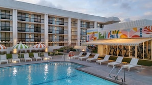 A hotel with a swimming pool, outdoor seating, and a colorful mural. - Avatar Hotel Santa Clara, Tapestry Collection by Hilton (Santa Clara)