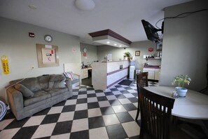 Cozy retreat with a sofa, dining table, and kitchenette, perfect for a relaxing stay.
