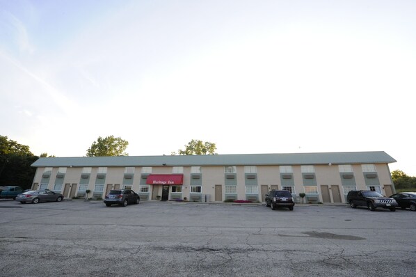 Guests can park their vehicles in the available parking lot and enter the building through the central entrance.