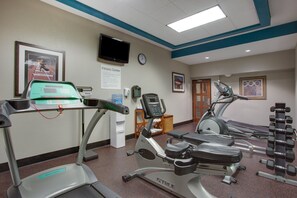 A fitness center with treadmills, an elliptical, and a water dispenser. - Holiday Inn Express Washington DC East - Andrews AFB by IHG (Suitland)