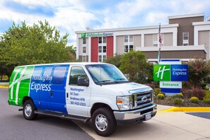 A Holiday Inn Express van parked in front of the hotel. - Holiday Inn Express Washington DC East - Andrews AFB by IHG (Suitland)