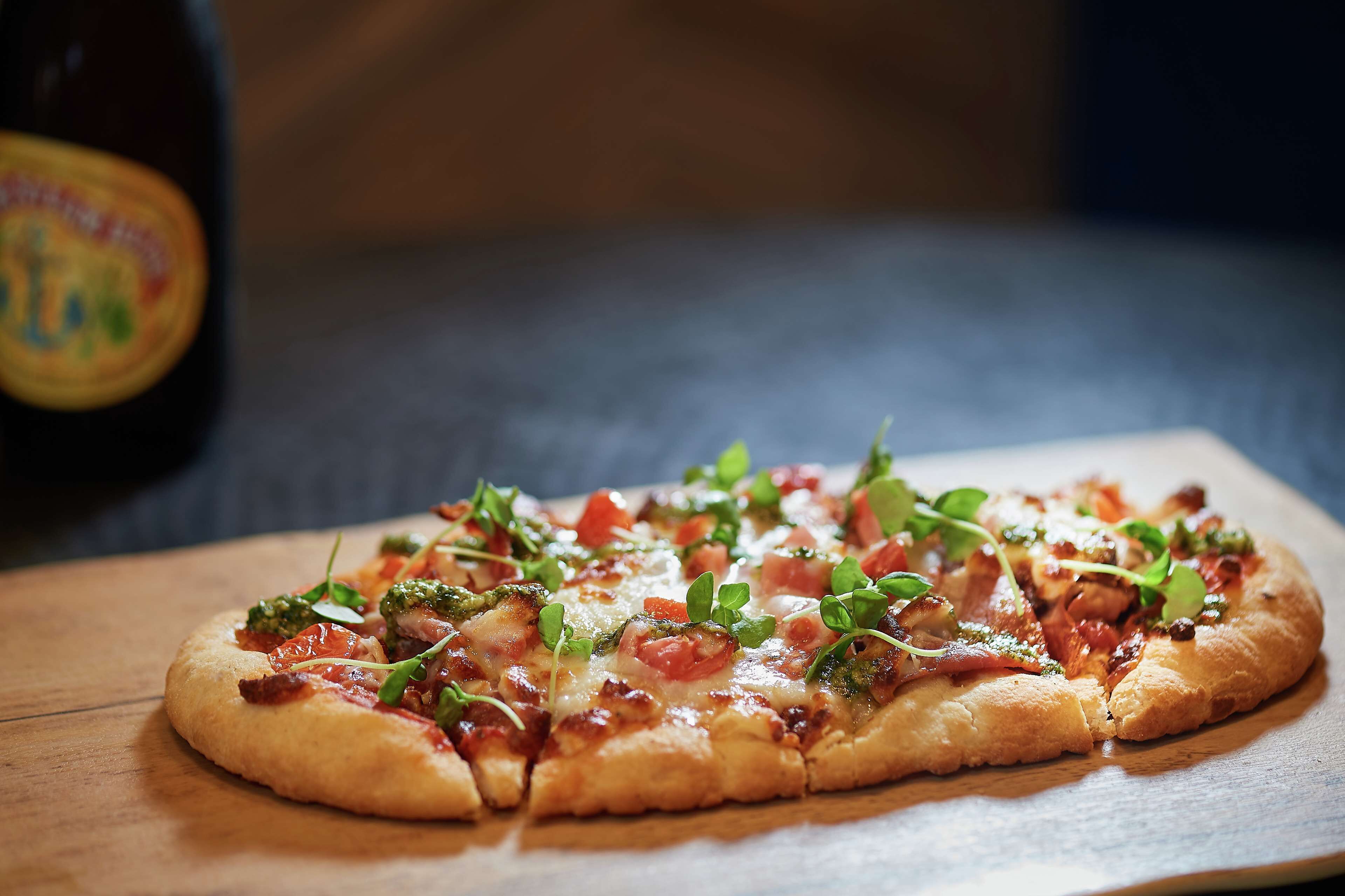 A pizza on a wooden board.