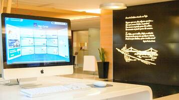 Un mostrador de recepción con un monitor que muestra una interfaz Web Courier, un teclado y un ratón.
