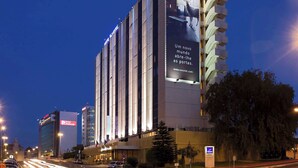 A hotel with a large billboard advertising a new world opening its doors. - Novotel Lisboa (Lisbon)