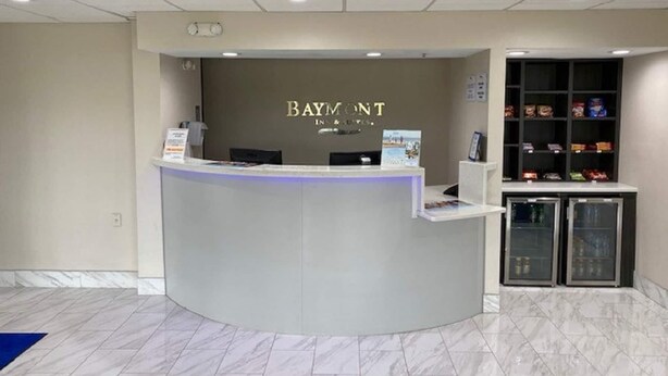A reception desk with a sign reading 'BAYMONT INN & RESORTS.' - Baymont by Wyndham Topeka (Topeka)