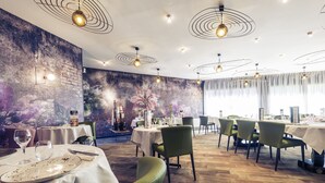 A restaurant with multiple tables, green chairs, and a mural on the wall. - Mercure Bourg En Bresse (Bourg-en-Bresse)