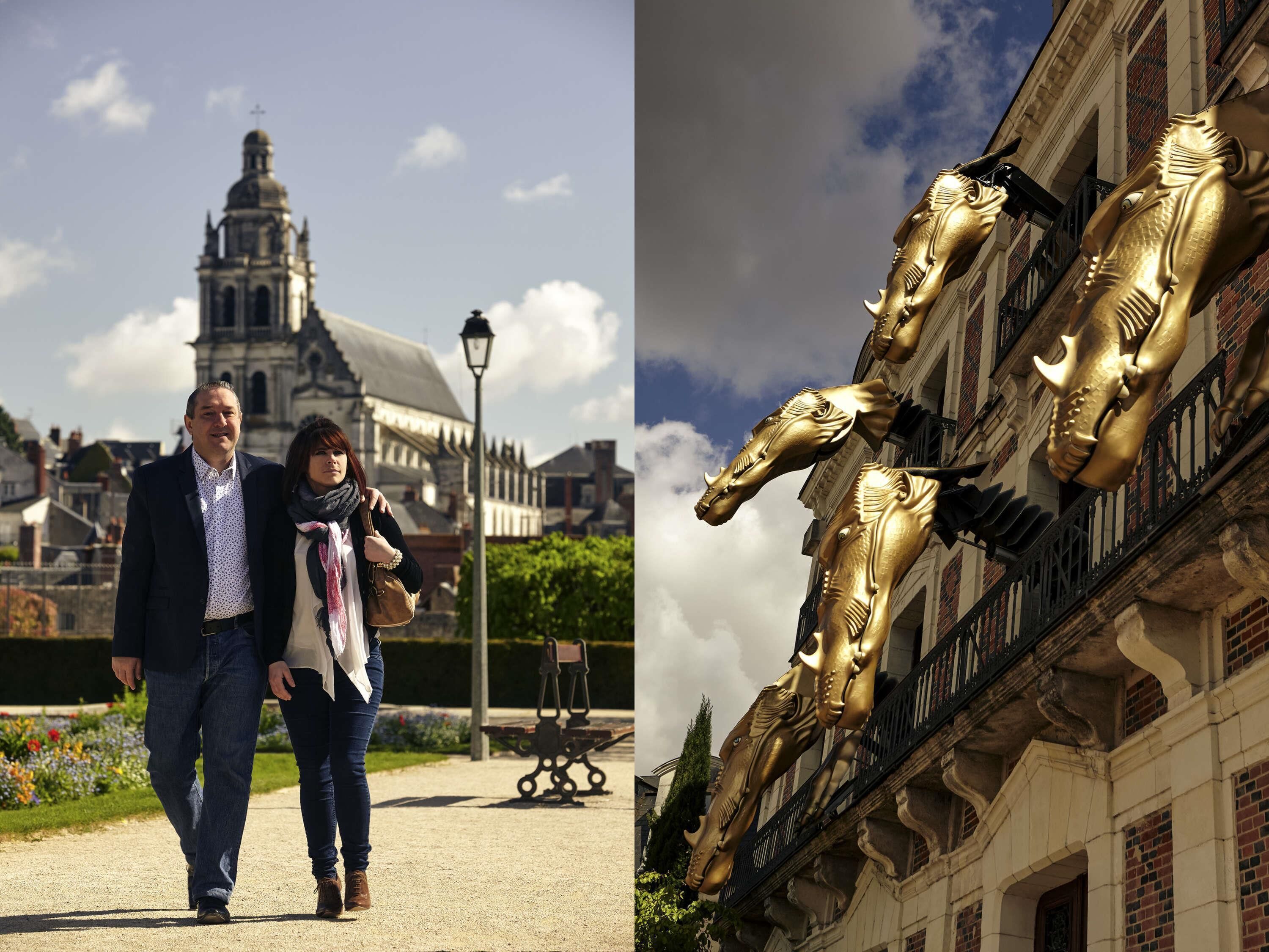 Un edificio histórico con una torre destacada y esculturas ornamentales de caballos dorados.